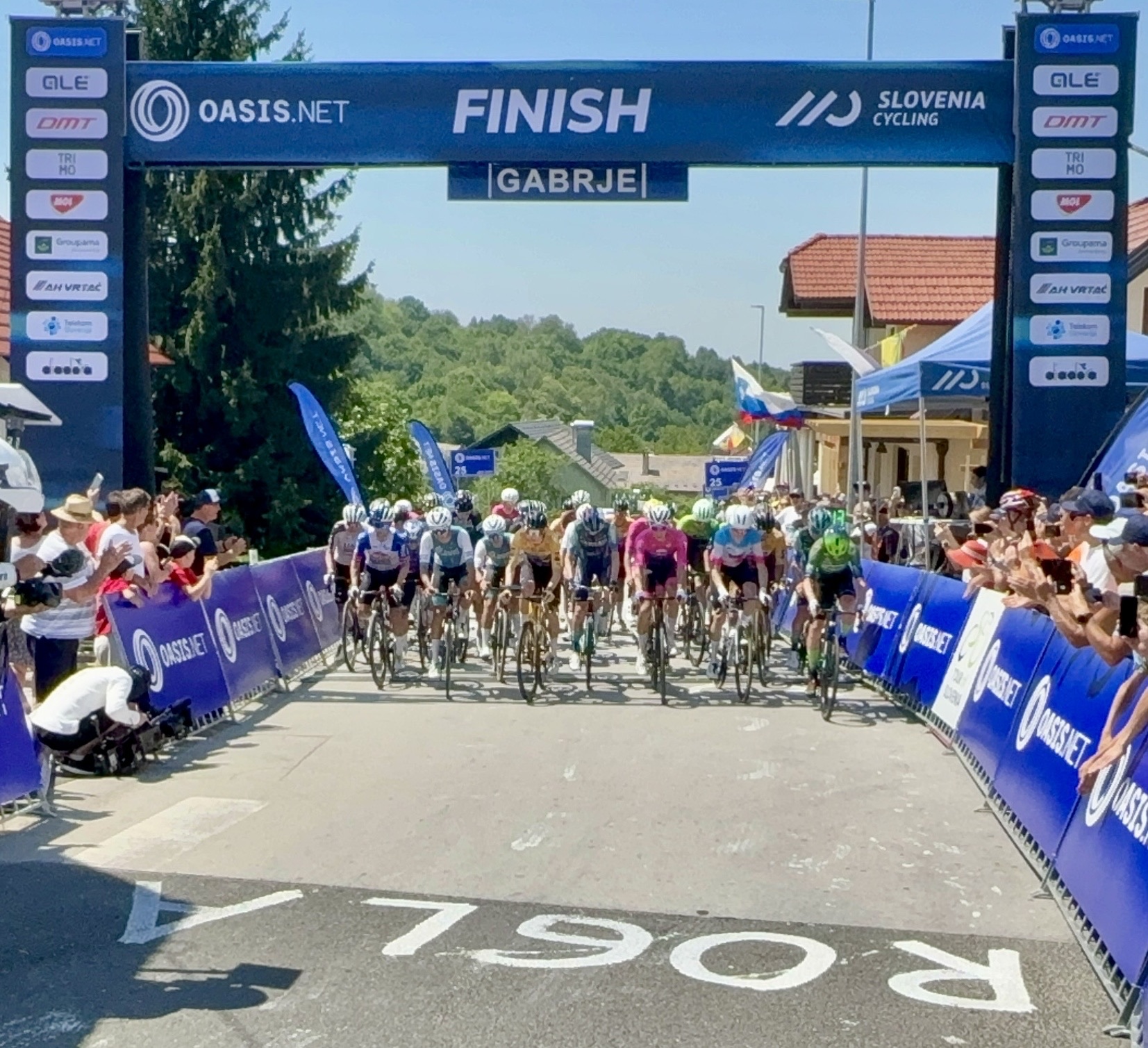 Riders lined up under the Oasis finish gantry at the 2026 Slovenian Road National Championships in Gabrje